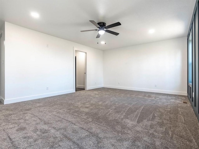 carpeted spare room with ceiling fan