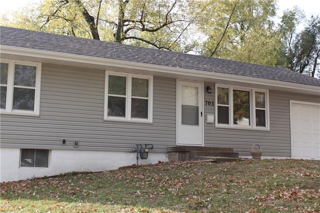 single story home with a front lawn and a garage