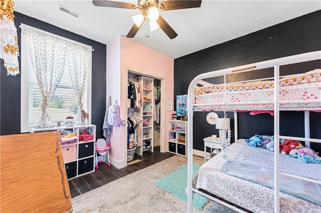 bedroom featuring ceiling fan, a closet, and dark wood-type flooring