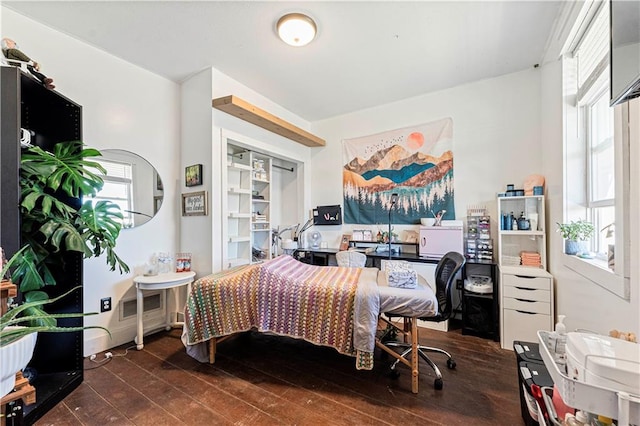 bedroom with dark hardwood / wood-style flooring