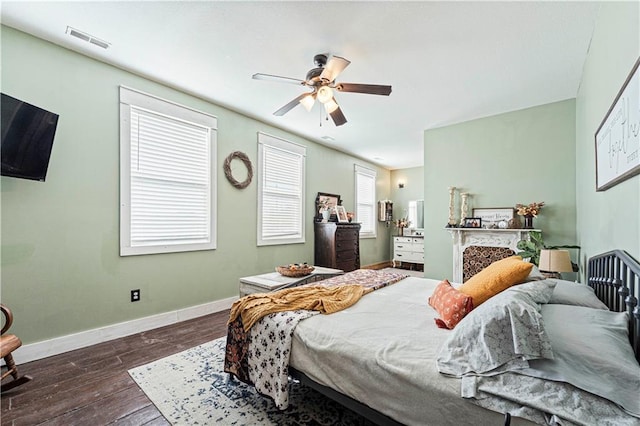 bedroom with dark hardwood / wood-style floors and ceiling fan