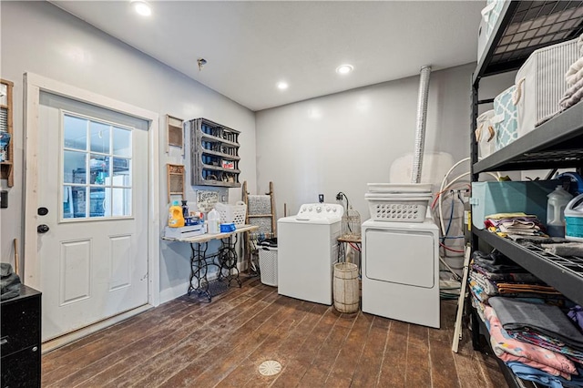 clothes washing area featuring washer and clothes dryer and dark wood-type flooring