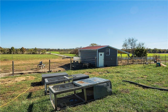 view of yard featuring a rural view and an outbuilding