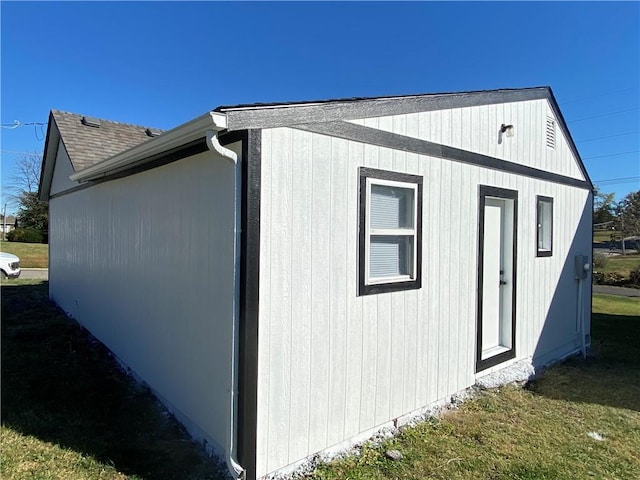 view of outbuilding with a yard