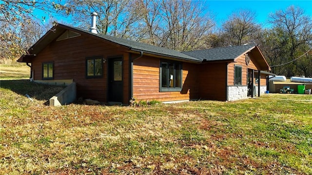 view of property exterior featuring a lawn