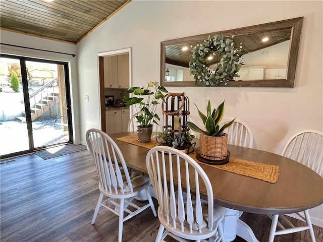 dining room with visible vents, lofted ceiling, wood ceiling, and wood finished floors