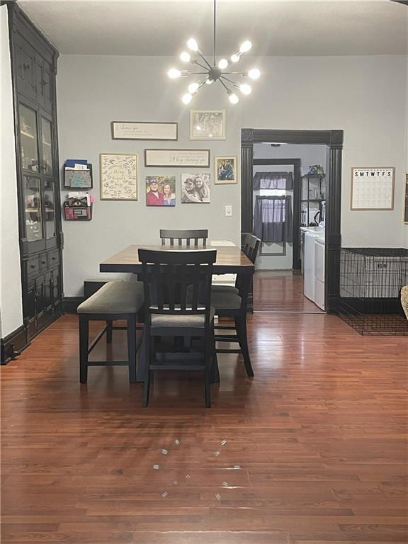 513 W Ohio St, Butler, MO 64730 - dining room featuring a chandelier, dark wood-style floors, and independent washer and dryer