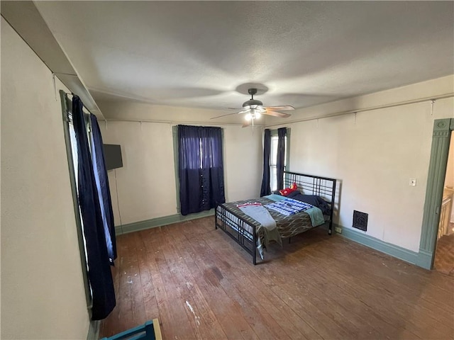 bedroom with hardwood / wood-style flooring and ceiling fan