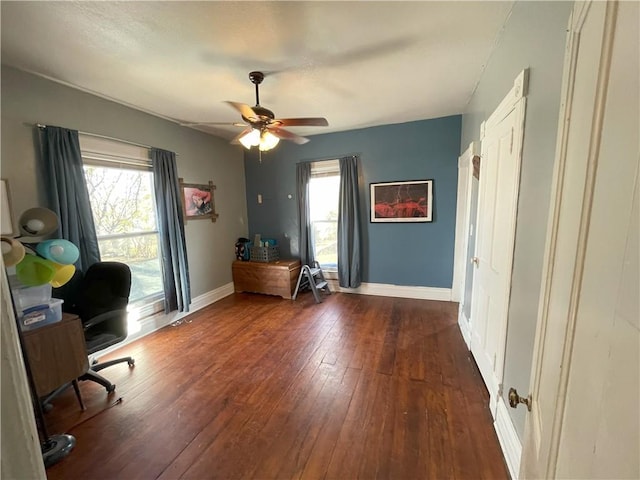 unfurnished office featuring ceiling fan and dark wood-type flooring