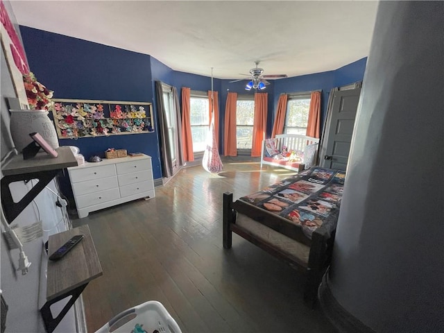 bedroom with ceiling fan and dark wood-type flooring