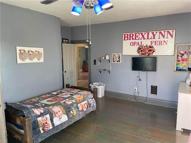 bedroom with ceiling fan and dark hardwood / wood-style flooring