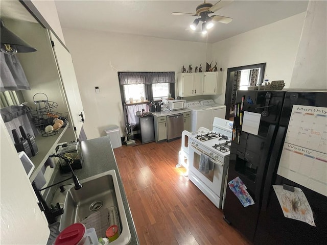 513 W Ohio St, Butler, MO 64730 - kitchen with white appliances, washer and clothes dryer, ceiling fan, and healthy amount of natural light