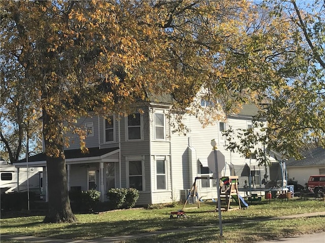 view of front of property featuring a trampoline and a front yard