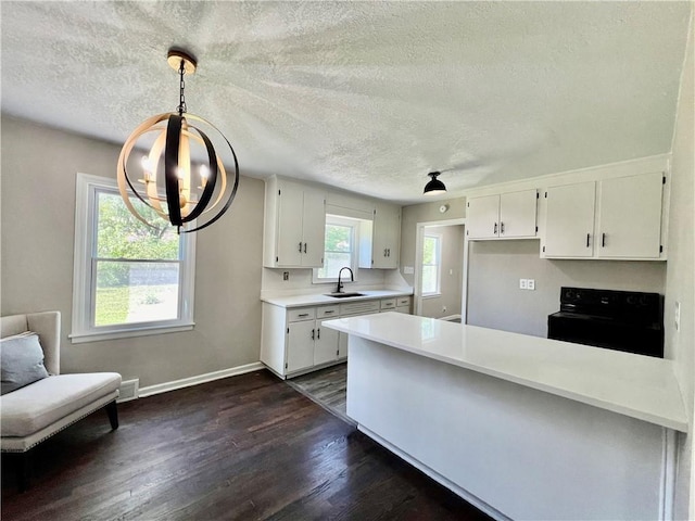 kitchen with white cabinets, black electric range oven, hanging light fixtures, and dark wood-type flooring