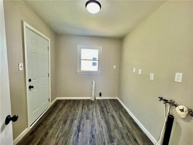 clothes washing area with dark hardwood / wood-style floors