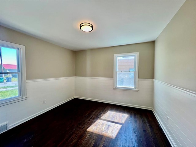 unfurnished room featuring dark hardwood / wood-style floors