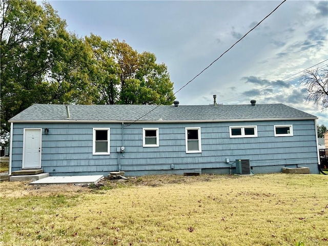 back of property featuring central air condition unit, a patio area, and a lawn