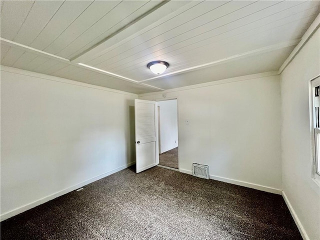 10406 E Lexington Ave, Independence, MO 64053 - spare room featuring dark carpet, wood ceiling, and baseboards