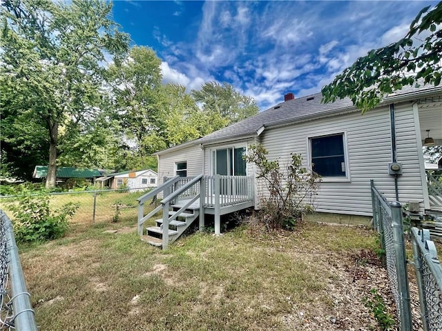 rear view of property featuring a yard