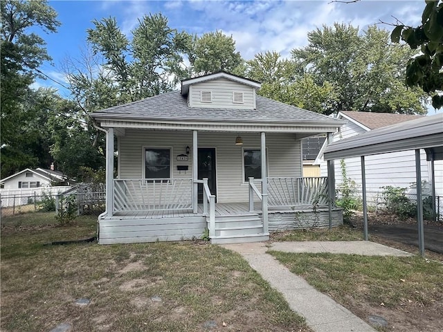 bungalow-style home with a porch and a front lawn