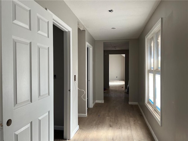 hallway with hardwood / wood-style floors