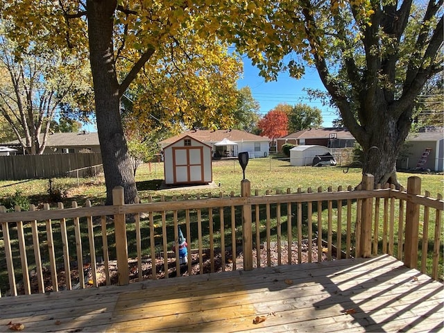 wooden deck featuring a lawn and a shed