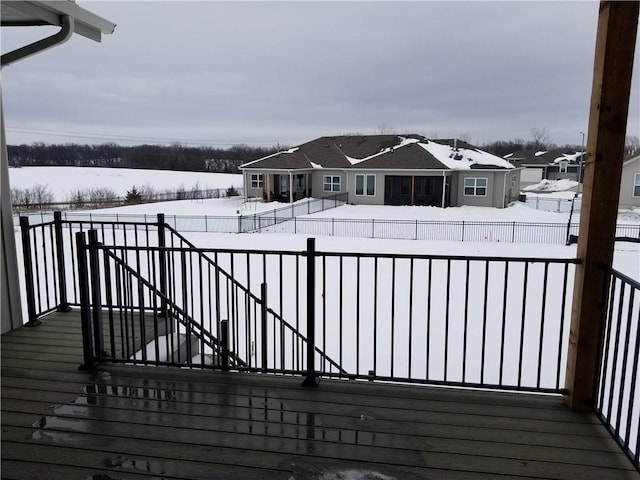 snow covered deck with fence private yard