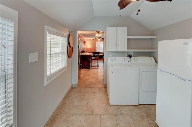 clothes washing area featuring cabinets, ceiling fan, washing machine and dryer, and light tile patterned floors