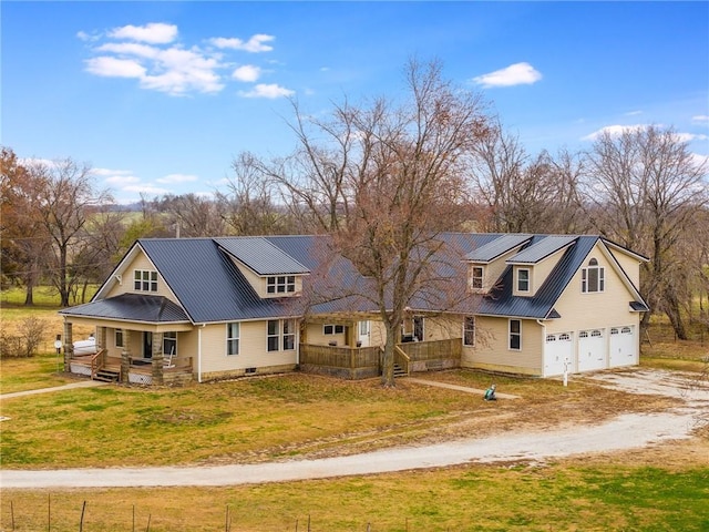 view of front of home featuring covered porch, solar panels, a garage, and a front lawn