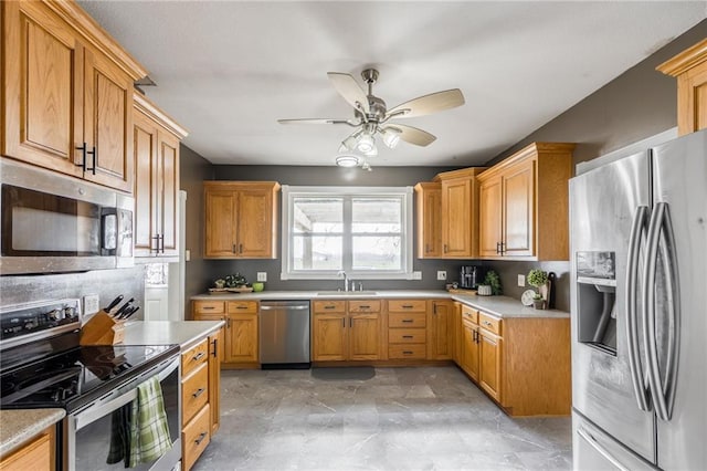 kitchen with ceiling fan, sink, and appliances with stainless steel finishes