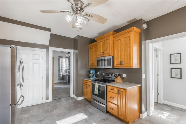 kitchen with appliances with stainless steel finishes and ceiling fan