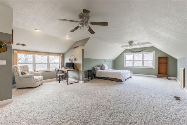 carpeted bedroom featuring ceiling fan, lofted ceiling, and a textured ceiling