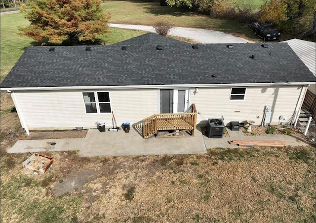 rear view of house featuring a patio area, a yard, and cooling unit