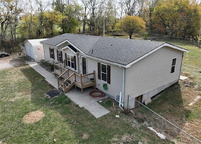 back of house with a lawn and a patio area