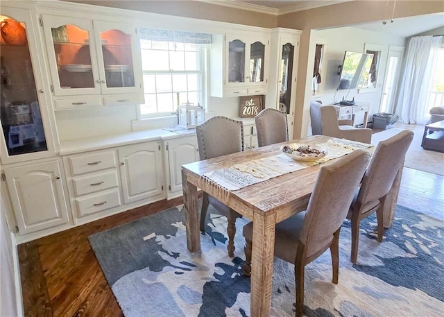 dining room featuring dark wood finished floors and ornamental molding