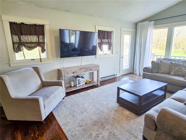 living area with a baseboard heating unit, wood finished floors, and vaulted ceiling