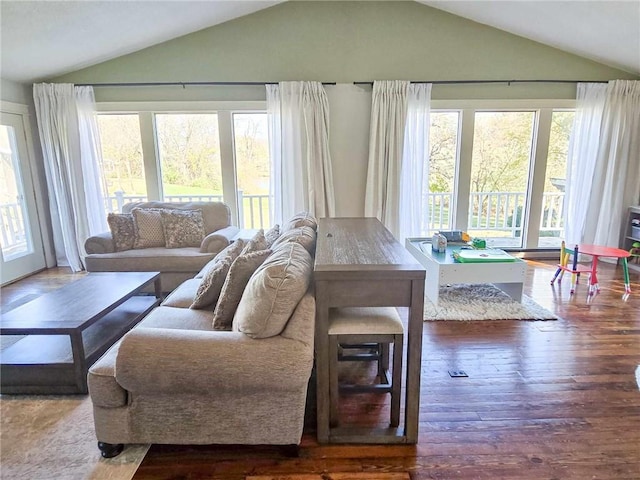 living room with lofted ceiling and wood finished floors