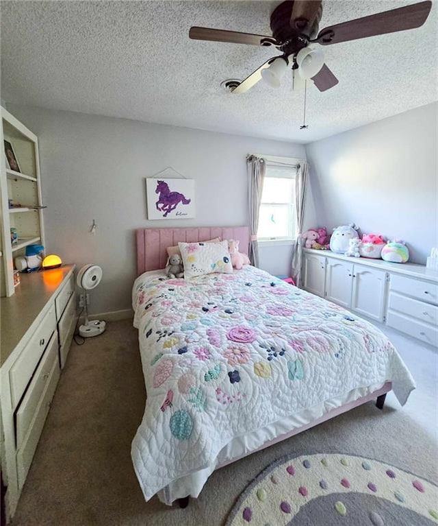 carpeted bedroom with baseboards, a textured ceiling, and ceiling fan