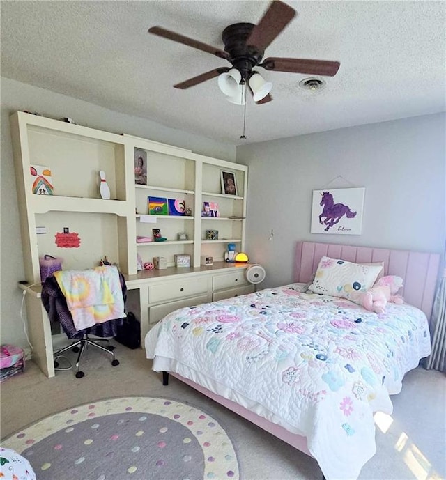 carpeted bedroom with a ceiling fan, visible vents, and a textured ceiling