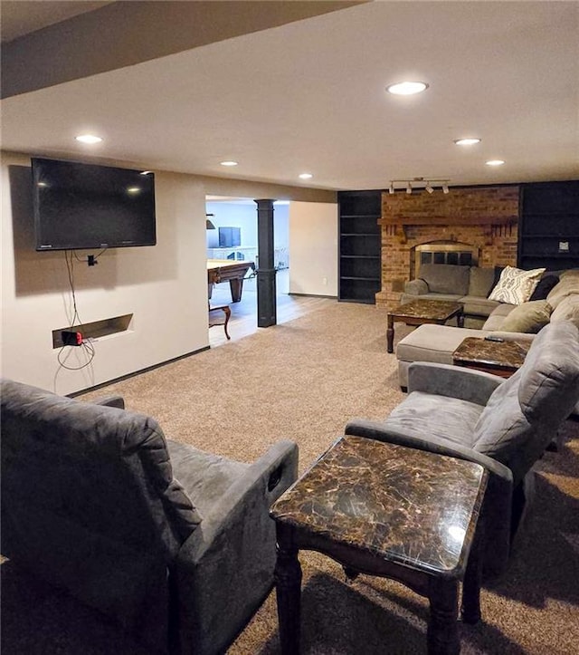 carpeted living room featuring recessed lighting, a brick fireplace, and track lighting