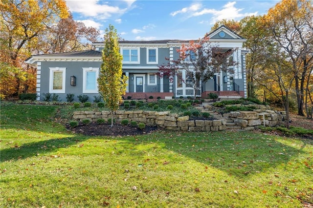 view of front of property featuring a front lawn and stucco siding