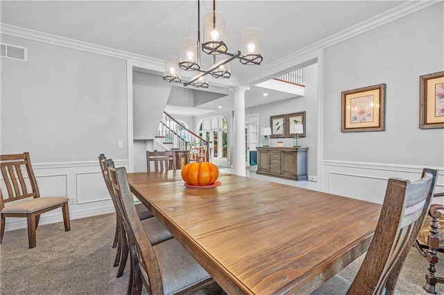 dining space with carpet floors, visible vents, stairway, ornamental molding, and ornate columns