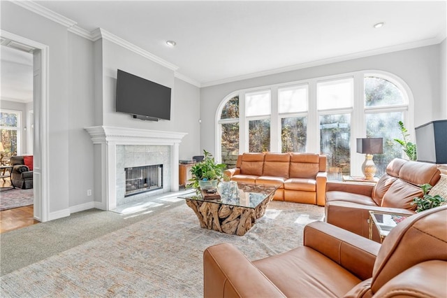 carpeted living area featuring ornamental molding, plenty of natural light, and a tiled fireplace