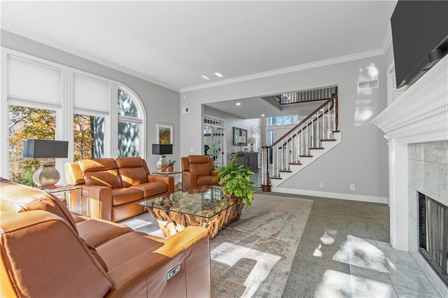 carpeted living area with stairs, ornamental molding, a tile fireplace, and visible vents