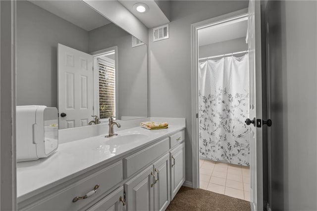 full bath with tile patterned flooring, visible vents, and vanity