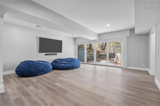 interior space with visible vents, baseboards, and wood finished floors