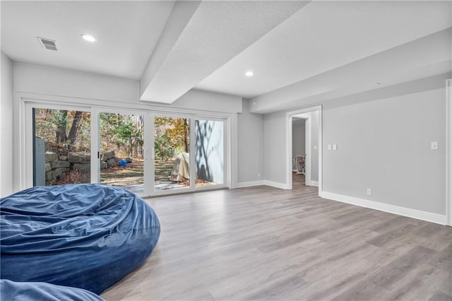 interior space featuring visible vents, baseboards, and wood finished floors