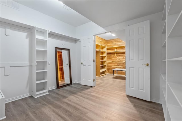 spacious closet featuring visible vents and wood finished floors