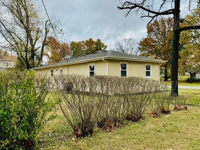 view of side of home with a lawn