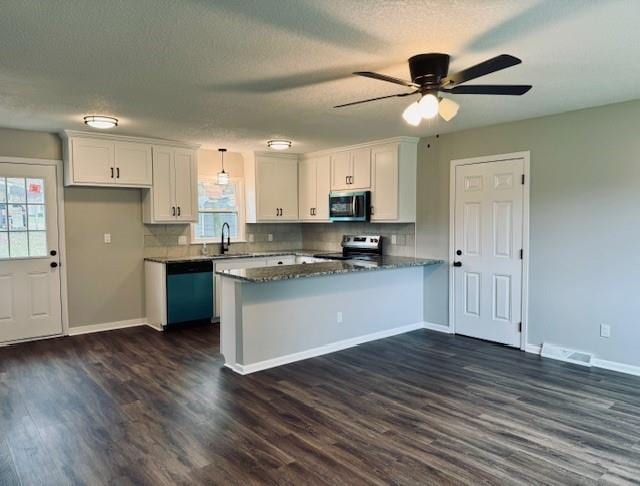 kitchen with white cabinetry, stainless steel appliances, and dark wood-type flooring